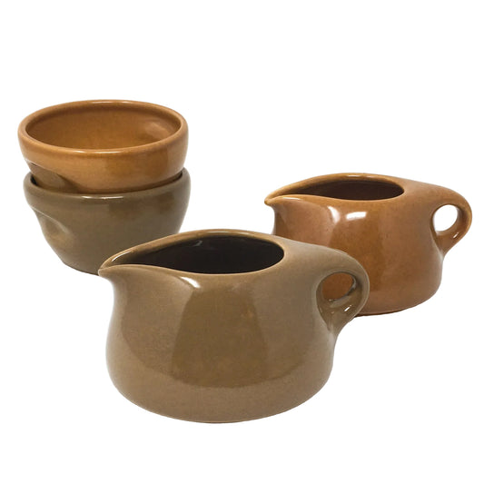 Set of brown ceramic bowls and pitchers on a white background