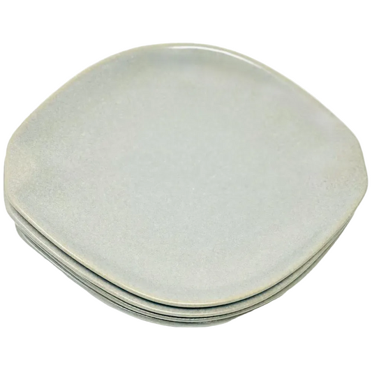 Stack of light gray ceramic plates on a white background